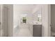Bright bathroom featuring double vanity, walk-in shower with white marble tile, and a soaking tub by the window at 625 Kimberwick Dr, Locust Grove, GA 30248