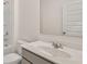 Bright bathroom with a single sink vanity, large mirror and a shower-tub combo at 625 Kimberwick Dr, Locust Grove, GA 30248