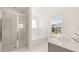 Bright bathroom featuring shower, tub, dual sinks and a window for natural lighting at 625 Kimberwick Dr, Locust Grove, GA 30248