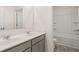 Bright bathroom features a double vanity with white countertop and tiled shower at 625 Kimberwick Dr, Locust Grove, GA 30248