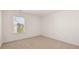 Empty bedroom with neutral-toned carpet and a large window providing natural light at 625 Kimberwick Dr, Locust Grove, GA 30248