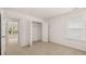 Well-lit bedroom with neutral tones, closet, and a view to an adjacent room at 625 Kimberwick Dr, Locust Grove, GA 30248