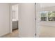 Bedroom featuring a view to the bathroom, and a large window for natural light at 625 Kimberwick Dr, Locust Grove, GA 30248
