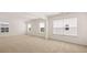 Bright bedroom with neutral carpet, white walls, and ample natural light streaming through multiple windows at 625 Kimberwick Dr, Locust Grove, GA 30248