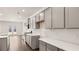 Spacious kitchen with modern appliances, white subway tile backsplash, gray cabinets, and wood-look flooring at 625 Kimberwick Dr, Locust Grove, GA 30248