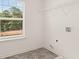 Well-lit laundry room featuring a large window, utility hookups, and wire shelving at 625 Kimberwick Dr, Locust Grove, GA 30248
