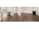 Open-concept living space features a fireplace, hardwood floors, and seamless kitchen access at 625 Kimberwick Dr, Locust Grove, GA 30248