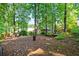 The peaceful, wooded backyard has plenty of trees, plants, and room to make your own at 2610 Chadwick Rd, Marietta, GA 30066