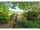An old, wood bridge adds beauty to the yard of this stunning single-Gathering home at 2610 Chadwick Rd, Marietta, GA 30066