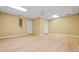 A finished basement offers a large, open space with wood-look flooring and neutral paint at 2610 Chadwick Rd, Marietta, GA 30066
