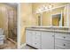 Bathroom features a granite countertop, white cabinetry, and tiled walk-in shower at 2610 Chadwick Rd, Marietta, GA 30066