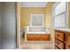 Bathroom with a tiled floor, a soaking tub, a frosted glass shower door, and a window at 2610 Chadwick Rd, Marietta, GA 30066