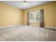 Bedroom with neutral walls, plush carpet, and a large window with natural light at 2610 Chadwick Rd, Marietta, GA 30066