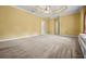 Spacious carpeted bedroom featuring a tray ceiling, ceiling fan, and a window seat at 2610 Chadwick Rd, Marietta, GA 30066