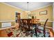Formal dining room boasts a chandelier, wood table, and colorful rug, ideal for Gathering gatherings at 2610 Chadwick Rd, Marietta, GA 30066