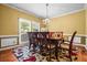 Formal dining room with chandelier, large table and chairs, and views of the backyard at 2610 Chadwick Rd, Marietta, GA 30066