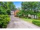 Long driveway leading to a brick home with a two-car garage and mature trees at 2610 Chadwick Rd, Marietta, GA 30066