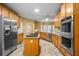 Spacious kitchen with stainless steel appliances, central island cooktop, tile flooring, and wood cabinets at 2610 Chadwick Rd, Marietta, GA 30066