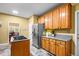 This kitchen is equipped with stainless steel appliances, oak cabinets, tile floors, and gas cooktop at 2610 Chadwick Rd, Marietta, GA 30066