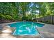 Refreshing pool surrounded by a concrete deck and mature trees at 2610 Chadwick Rd, Marietta, GA 30066