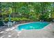 Tranquil backyard with a sparkling pool, lush greenery, and comfortable seating at 2610 Chadwick Rd, Marietta, GA 30066