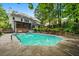 Backyard view of the refreshing in-ground pool and covered deck of this lovely home at 2610 Chadwick Rd, Marietta, GA 30066