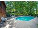 Inviting backyard pool area featuring a clear blue pool, patio furniture, and lush greenery at 2610 Chadwick Rd, Marietta, GA 30066