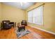Cozy sitting area with hardwood floors, multiple cushioned chairs, and bright natural light from a window at 2610 Chadwick Rd, Marietta, GA 30066