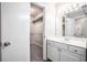 Bathroom with vanity, mirror, lighting, and walk-in closet at 3006 Alberta Dr, Marietta, GA 30062