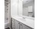 Bright bathroom with tile floors, shower and bath, and white vanity with chrome hardware at 3006 Alberta Dr, Marietta, GA 30062