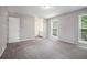 This spacious bedroom features neutral paint, plush carpet, and multiple windows at 3006 Alberta Dr, Marietta, GA 30062