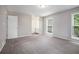 Bedroom features neutral paint and carpet, with a view of the bathroom and closet at 3006 Alberta Dr, Marietta, GA 30062