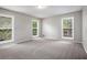 This spacious bedroom features neutral paint, plush carpet, and multiple windows at 3006 Alberta Dr, Marietta, GA 30062