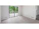 Light-filled bedroom with sliding glass doors leading to a deck and neutral-colored walls and carpet at 3006 Alberta Dr, Marietta, GA 30062