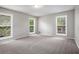 Spacious bedroom with carpeted floors and multiple windows letting in natural light at 3006 Alberta Dr, Marietta, GA 30062