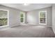 Spacious bedroom featuring multiple bright windows and neutral carpeting at 3006 Alberta Dr, Marietta, GA 30062