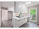 Modern kitchen with white cabinets, island, and view of the backyard at 3006 Alberta Dr, Marietta, GA 30062