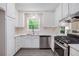 Bright kitchen features white cabinets, stainless steel appliances, and a large window at 3006 Alberta Dr, Marietta, GA 30062