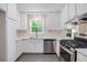 Bright kitchen with stainless steel appliances, white cabinets, and a view to the outdoors at 3006 Alberta Dr, Marietta, GA 30062
