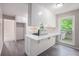 Charming kitchen featuring white cabinets and breakfast bar area with nature view at 3006 Alberta Dr, Marietta, GA 30062