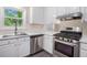 Bright kitchen featuring stainless steel appliances, white cabinetry, and modern countertops at 3006 Alberta Dr, Marietta, GA 30062
