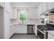 Bright kitchen with stainless steel appliances, white cabinetry, and views from the window above the sink at 3006 Alberta Dr, Marietta, GA 30062