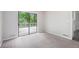 Bright room with neutral carpet, sliding doors leading to a deck and an exterior view at 3006 Alberta Dr, Marietta, GA 30062