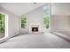 Spacious living room with fireplace, lots of windows, and a ceiling fan at 3006 Alberta Dr, Marietta, GA 30062