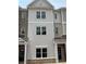 Charming townhome features a blend of brick and siding, creating a modern and inviting facade at 3338 Cranston Ln, Kennesaw, GA 30144