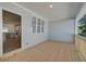 Covered wooden porch showcasing views of the kitchen and neighborhood at 3338 Cranston Ln, Kennesaw, GA 30144