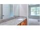 Bathroom vanity featuring granite countertop, wood cabinets, and large mirror at 4041 Ash Tree St, Snellville, GA 30039