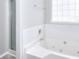 Relaxing bathroom offers a jetted tub with tile surround and glass door shower at 4041 Ash Tree St, Snellville, GA 30039