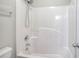 Bathroom features a shower-tub combination, a shower head, and a toilet at 4041 Ash Tree St, Snellville, GA 30039