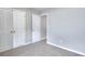 Carpeted bedroom with light gray walls, two standard closets, and a view into the hallway at 4041 Ash Tree St, Snellville, GA 30039